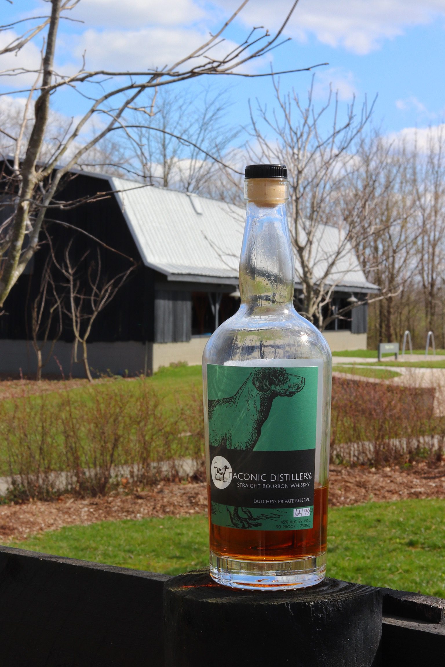 Bottle in front of barn