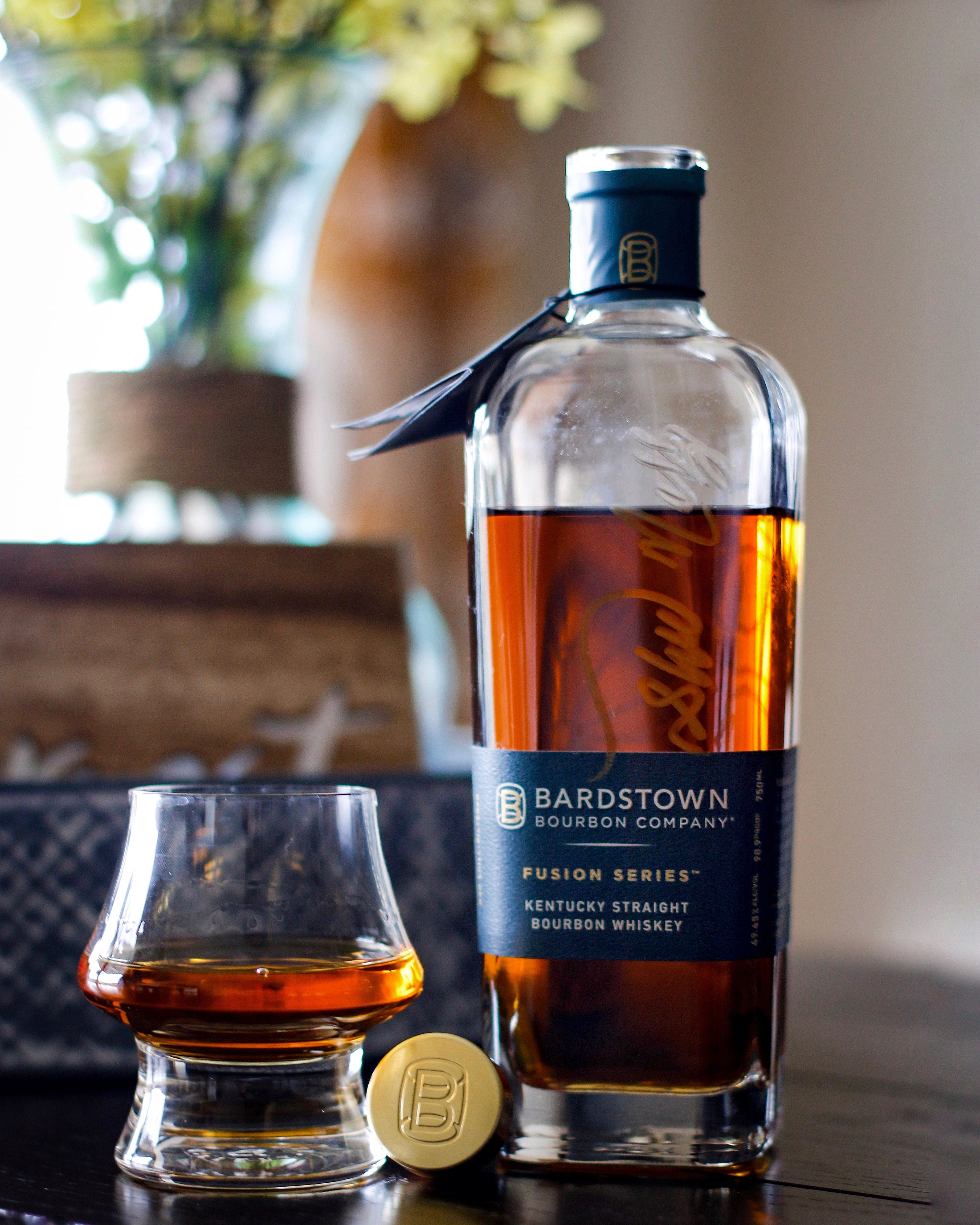 Bottle of bardstown bourbon company with flowers in the background