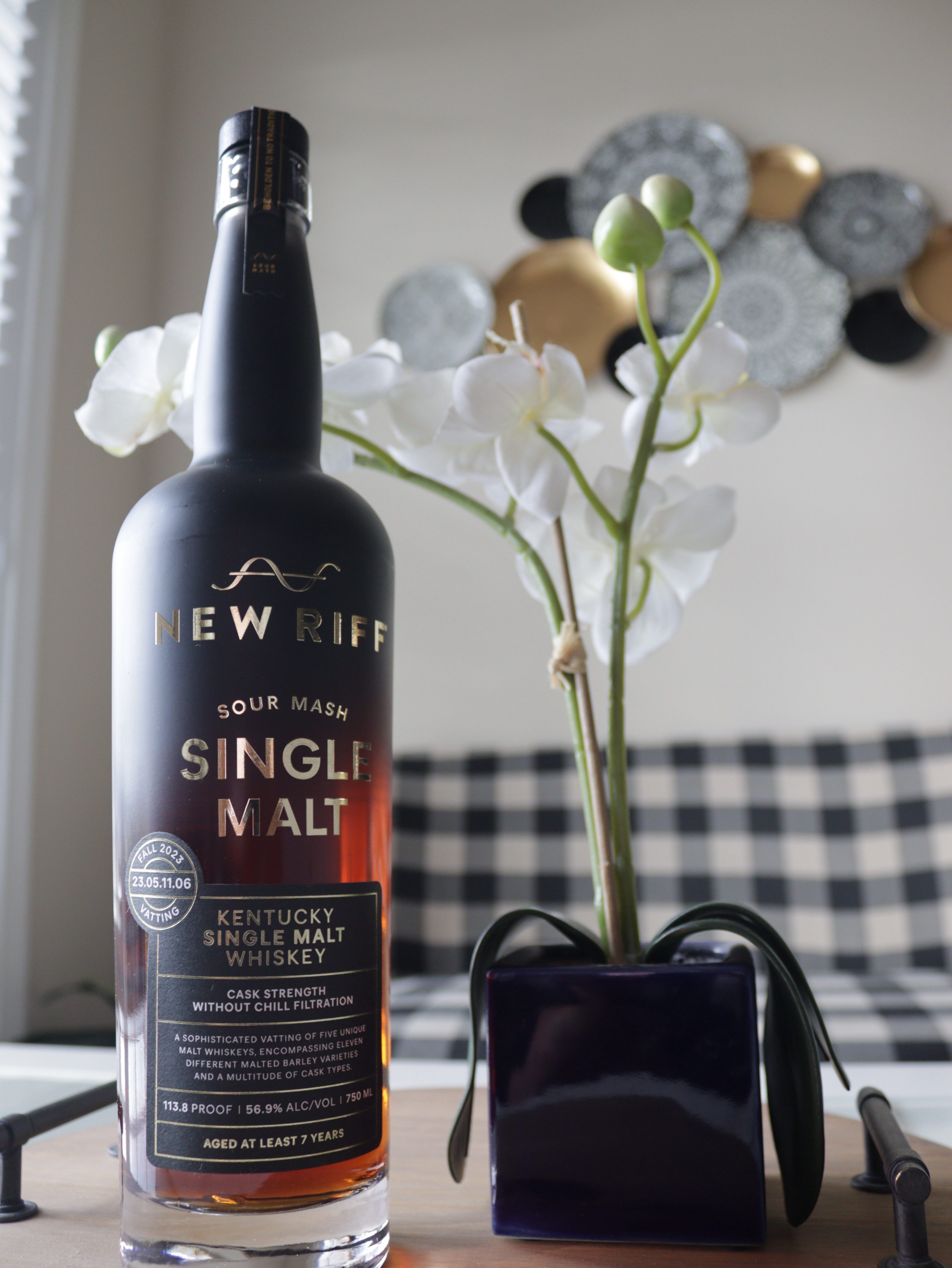 New Riff Single Malt with  flower and couch in the background