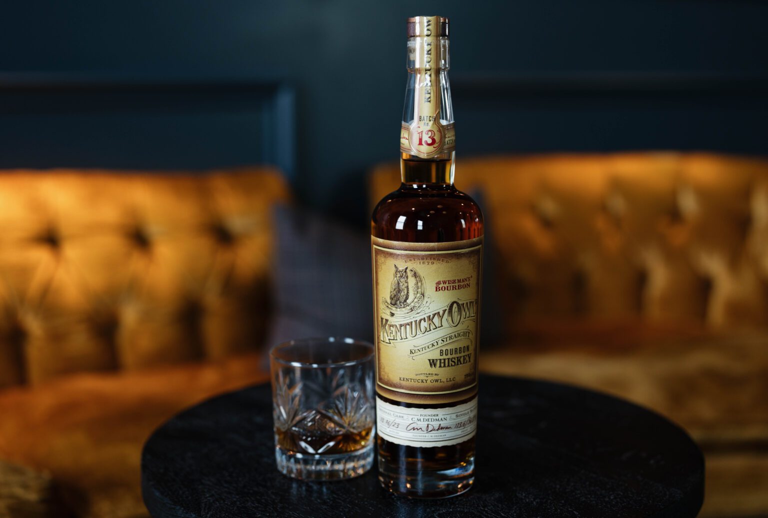 Bottle of Kentucky Owl Bourbon with a glass