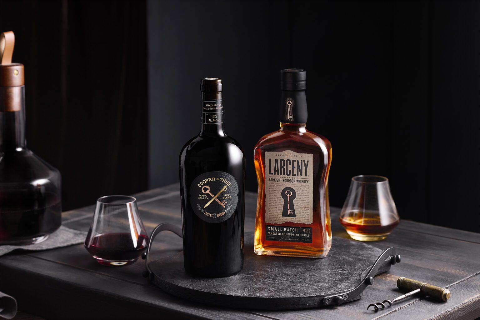 Bottle of the wine and bourbon next to each other on a plater