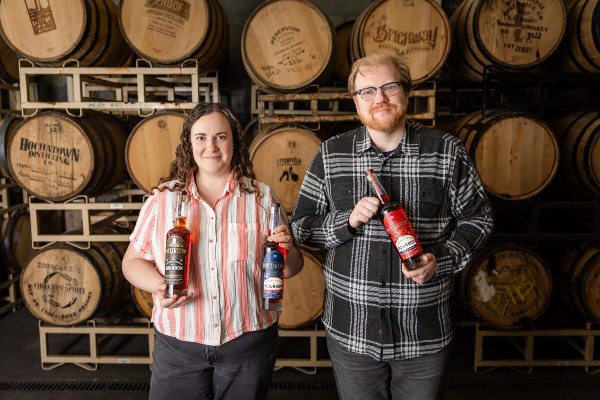 Adam and Nora holding 250th bottles