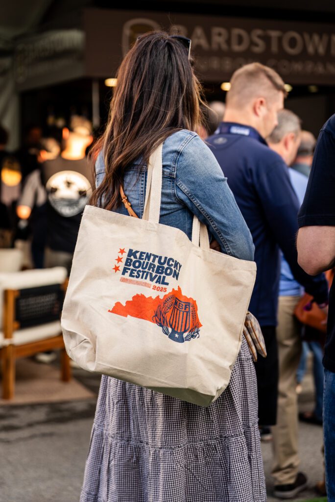 Person holding KBF bag at 2025 festival.