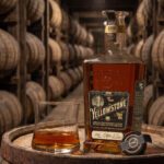 Yellowstone 2026 with a glass in a rickhouse